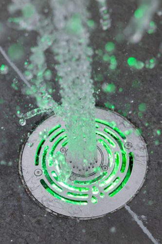 Close up of LED Jumping Jets in green with water coming out