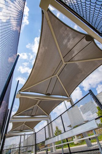 Shade over space between baseball fields.