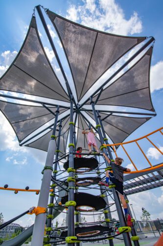 View looking up at the large heptagon shade structure.