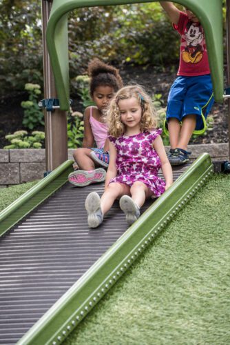 2 girls going down roller slide