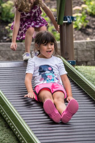 Girl going down roller slide