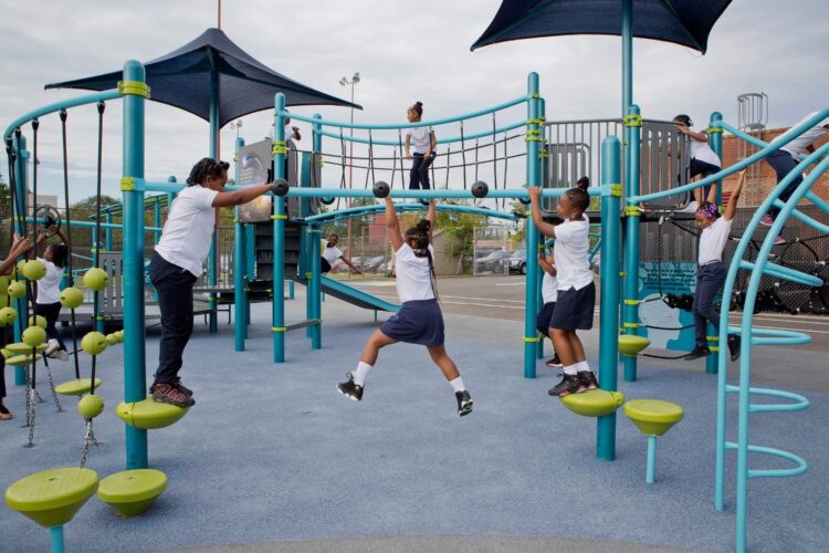 Kids playing on bars, crossing from one side to the other.