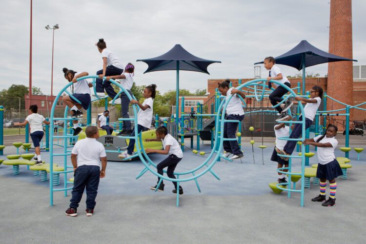 Kids playing on wavy climbing structure.
