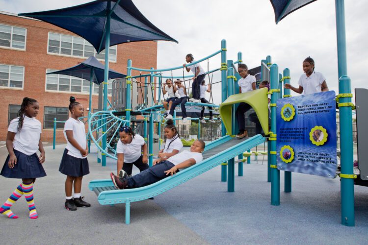 Kids playing on roller slide.