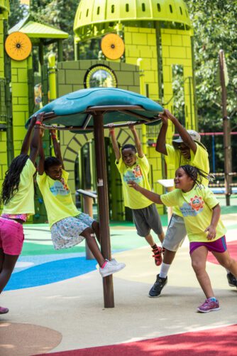 Kids playing on spinning equipment.