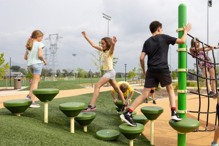 Kids playing on uneven climbing structures.