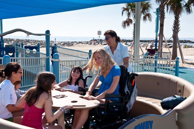 Group of kids playing on inclusive playground equipment.