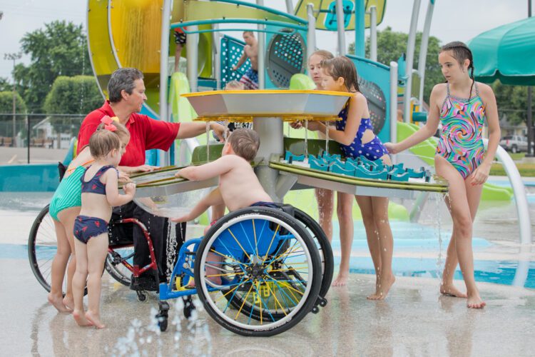 Kids playing together at splash pad.