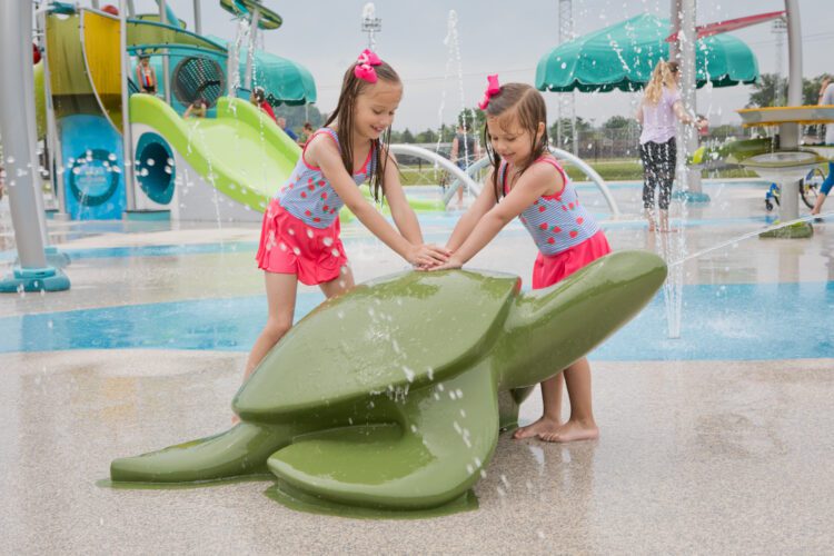 2 girls playing with turtle shaped jet.
