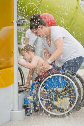 Mother helping son in wheelchair.