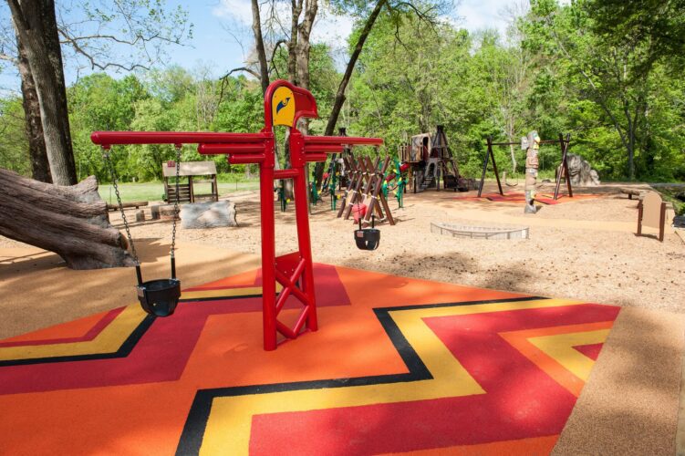 Custom totem pole swing set over bold zigzag-patterned PlayBound™ Pour-in-Place surfacing at the Indian Creek Playground in Berwyn Heights, MD, installed by Sparks at Play using LSI equipment.