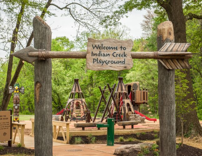 Custom welcome sign with Native American-inspired arrow and lettering at the Indian Creek Playground in Berwyn Heights, MD, installed by Sparks at Play using LSI equipment.