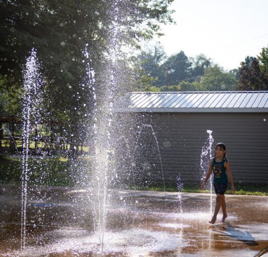 Ground spray water features at the City of Norton splash pad in Norton, Virginia, providing interactive sensory water play for children of all ages, installed by Sparks at Play using Aquatix equipment.