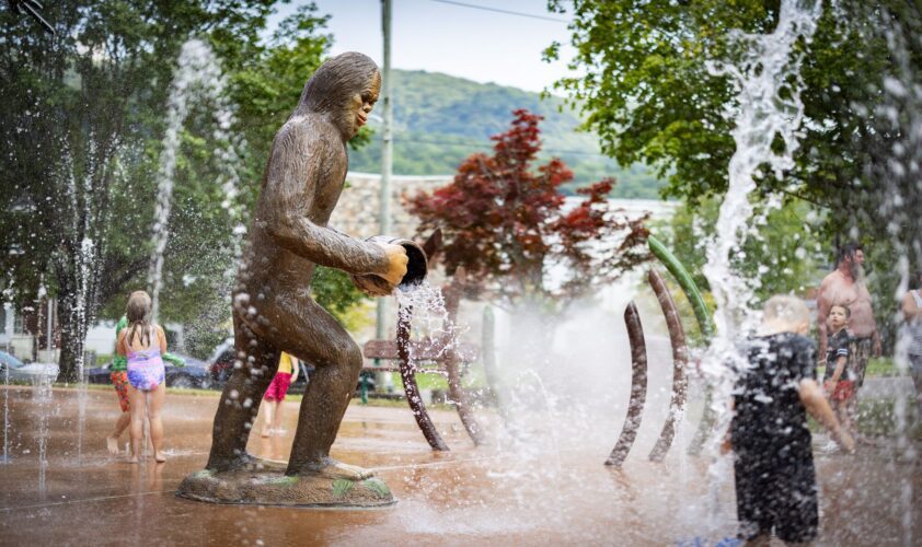 Custom GFRC Norton Wood Booger Bigfoot-inspired statue serving as an interactive water feature at the City of Norton splash pad in Norton, Virginia, installed by Sparks at Play.
