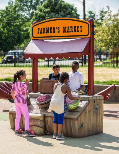 Kids playing at custom GFRC farmer's market play stand at Turkey Thicket Recreation Center playground Washington DC
