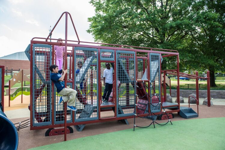 Kids climbing inside custom Landscape Structures train cart play structure at Turkey Thicket Recreation Center Washington DC