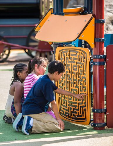 Kids playing with custom learning panel puzzle and maze at Turkey Thicket Recreation Center playground Washington DC