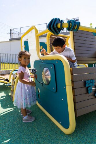 Children interacting with each other at the LSI Smart Play® Cube at the Jennie Dean Park playground in Arlington, VA, installed by Sparks at Play.