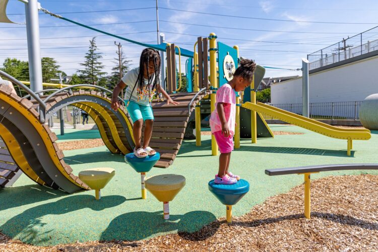 Children using Pod Steppers® at the Jennie Dean Park playground in Arlington, VA, installed by Sparks at Play using LSI equipment.
