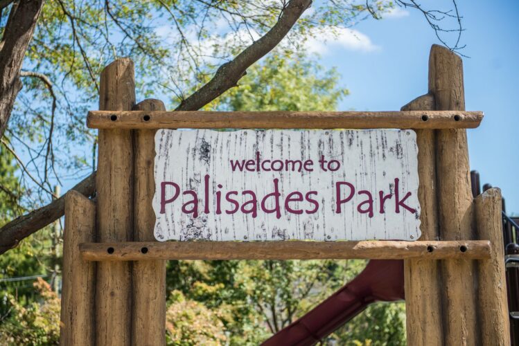 Custom welcome sign at the Palisades Recreation Center playground in Washington, DC, installed by Sparks at Play using LSI equipment.