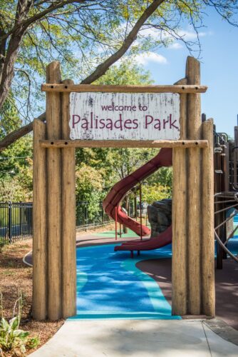 Custom welcome sign at the Palisades Recreation Center playground in Washington, DC, installed by Sparks at Play using LSI equipment.