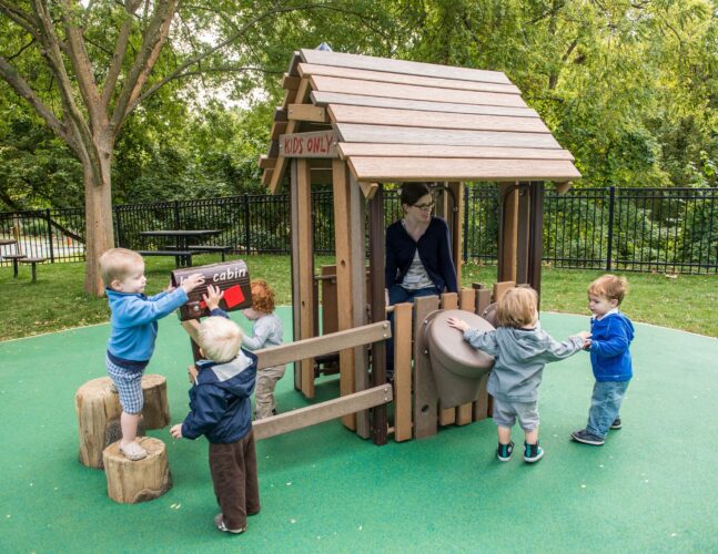 Custom kids log cabin at the Palisades Recreation Center playground in Washington, DC, installed by Sparks at Play using LSI equipment.
