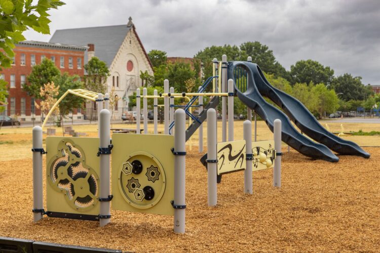 Overview of Franklin Square Elementary playground with gear panels music note panels and bongo reach panels Baltimore MD