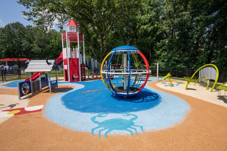 Beach-themed poured-in-place rubber surfacing with crab design and Global Motion at J. Franklyn Bourne Park Capitol Heights MD