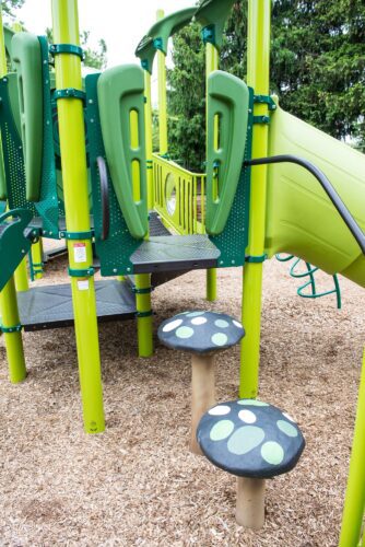 Custom grass-themed play structure with giant blade of grass climbers at the Prince George's County Childcare playground in Upper Marlboro, MD, installed by Sparks at Play using LSI equipment.