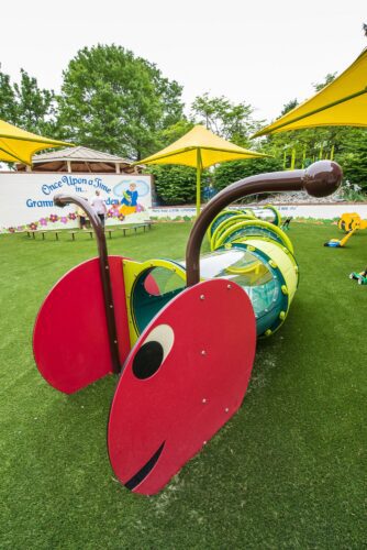 Custom Caterpillar Crawl Tunnel made from combined ground crawl tunnels at the Prince George's County Childcare playground in Upper Marlboro, MD, installed by Sparks at Play using LSI equipment.