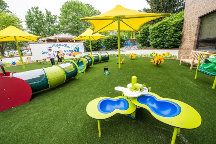 Custom Caterpillar Crawl Tunnel and elevated sand table at the Prince George's County Childcare playground in Upper Marlboro, MD, installed by Sparks at Play using LSI equipment.