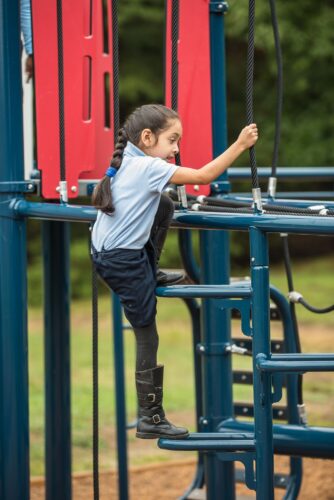 Kid climbing up steps of Landscape Structures Smart Play Venti at Princeton Elementary School playground Suitland MD
