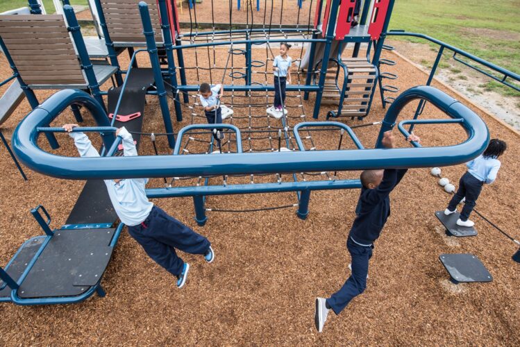 Overview of kids playing on Landscape Structures Smart Play Venti at Princeton Elementary School playground Suitland MD