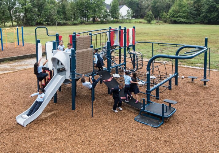 Overview of kids playing on Landscape Structures Smart Play Venti at Princeton Elementary School playground Suitland MD