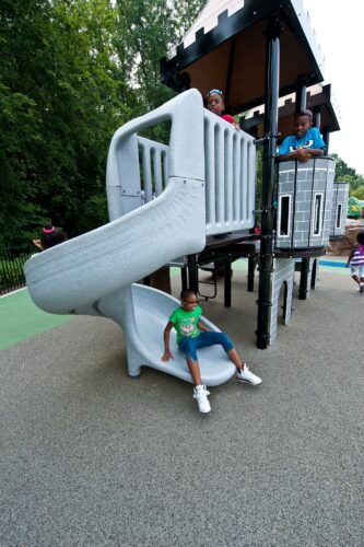 Custom PlayBooster® castle play structure with fortress towers and a SpyroSlide™ at the medieval-themed South Bowie Community Center playground in Bowie, MD.