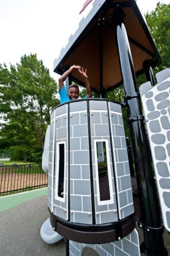 Custom PlayBooster® castle play structure with fortress towers and a SpyroSlide™ at the medieval-themed South Bowie Community Center playground in Bowie, MD.