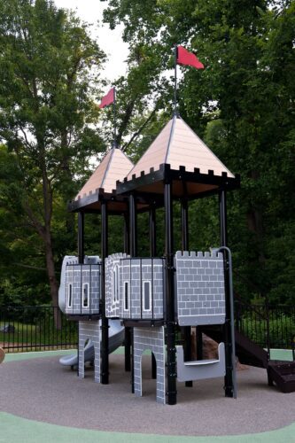 Custom PlayBooster® castle play structure with fortress towers and a SpyroSlide™ at the medieval-themed South Bowie Community Center playground in Bowie, MD.