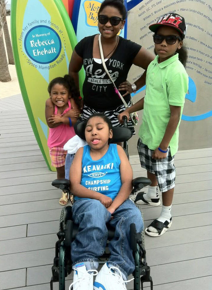 Adiana, Ele, AJ, and Ahmahry as kids together at the Grommet Island Beach Park inclusive playground in Virginia Beach, Virginia.